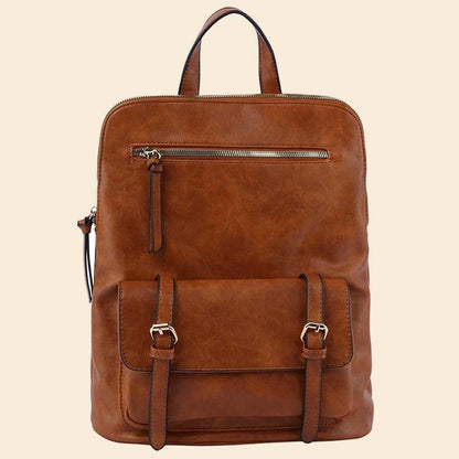 Brown leather backpack with front zipper and buckle pocket on a beige background.