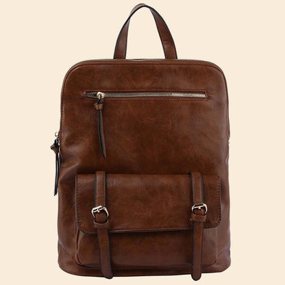 Brown leather backpack with front pocket, buckle straps, and zipper detail on a beige background.