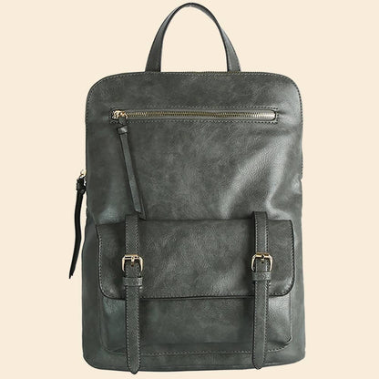 Dark gray leather backpack with front pocket, buckle straps, and zipper detail on a beige background.