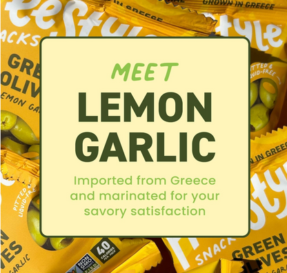 Freestyle Snacks Lemon Garlic Green Olives packaging with text overlay promoting Greek origin and savory flavor.