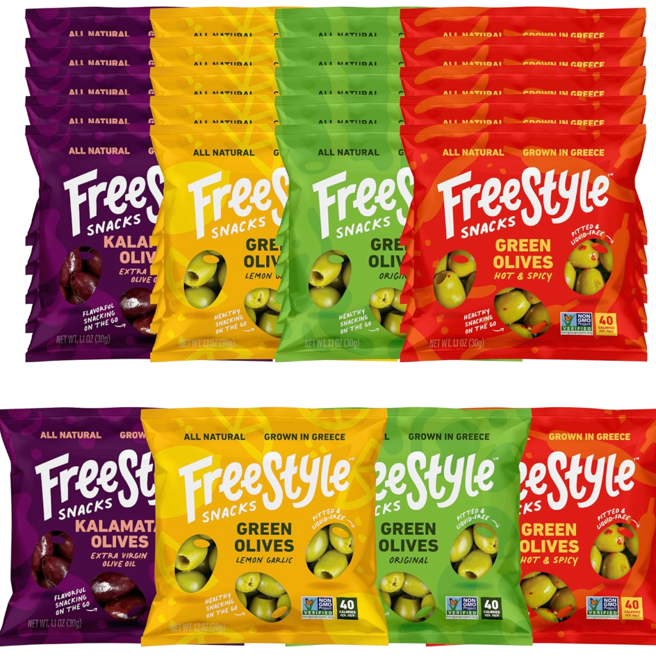 Assorted Freestyle Snacks olive packages including Kalamata, Lemon Garlic, Original, and Hot & Spicy flavors, stacked in colorful packaging.