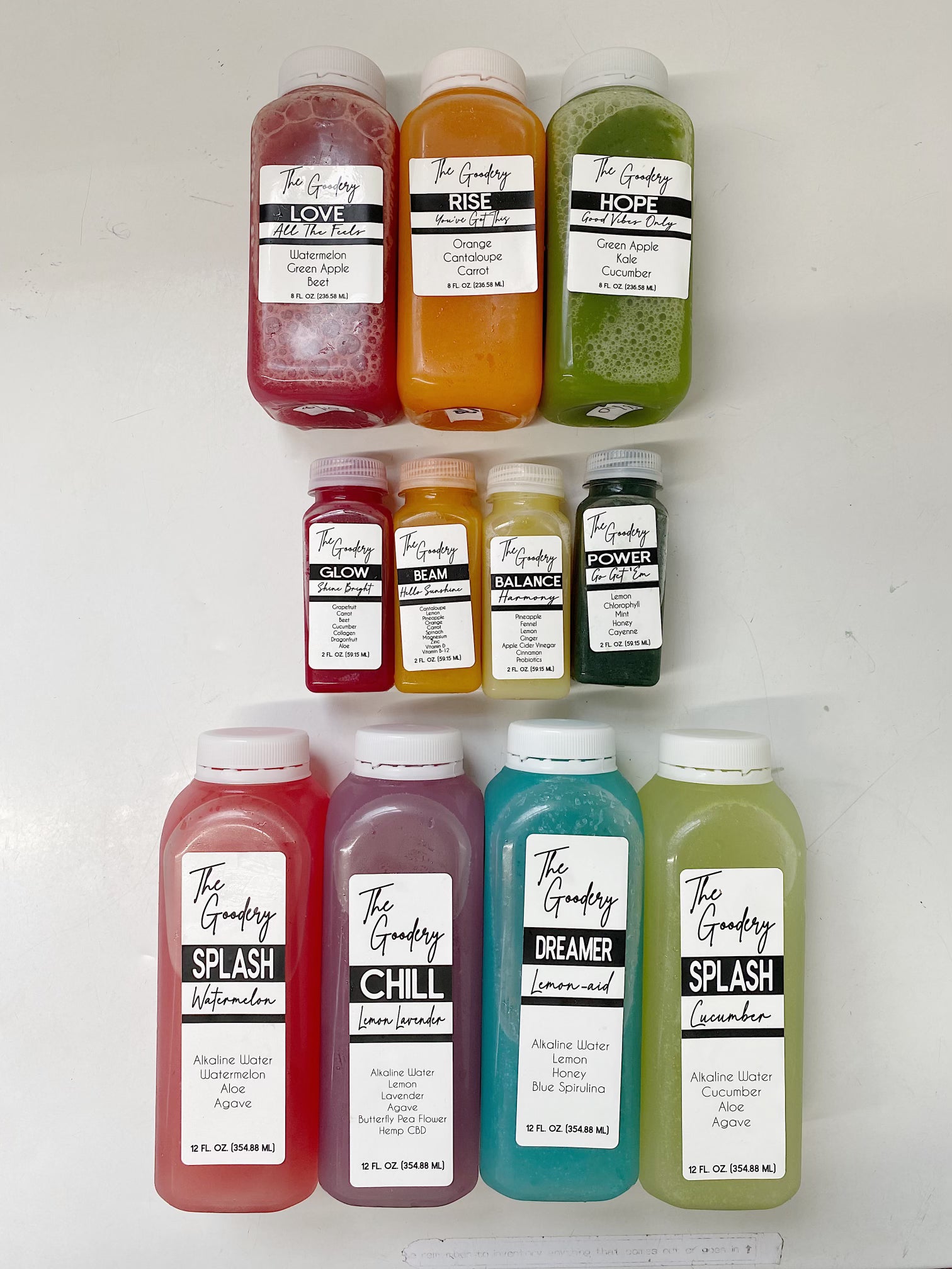 The Goodery cold-pressed juice collection with multiple flavors including Love, Rise, Hope, Splash, Chill, Dreamer, Balance, Power, and Glow displayed on a white background.