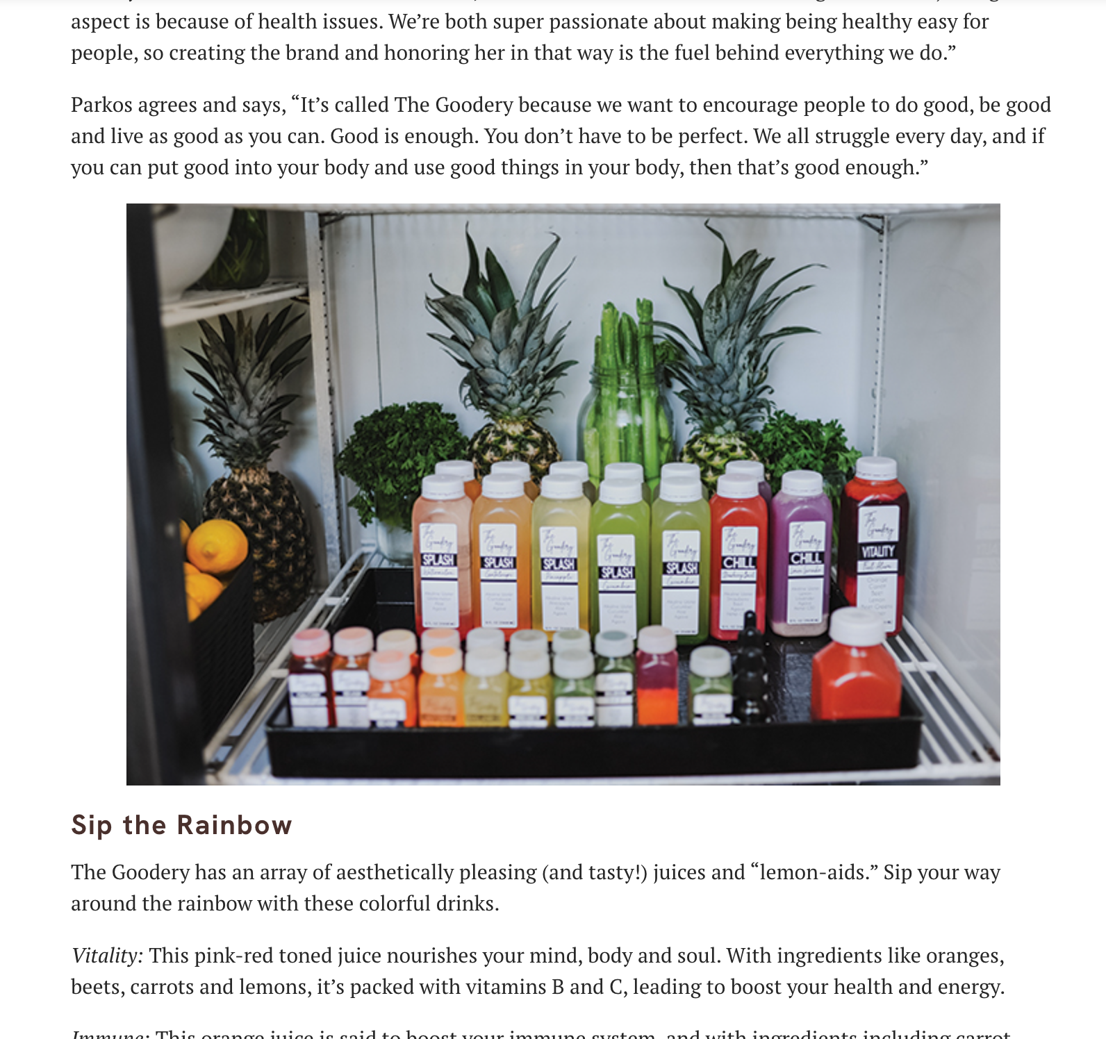 The Goodery cold-pressed juices in rainbow colors displayed in a refrigerator with pineapples and greens, featured in a press article