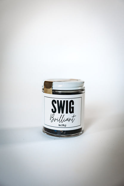 Swig Tea Blend Brilliant loose leaf tea in glass jar with white lid, displayed on white background.
