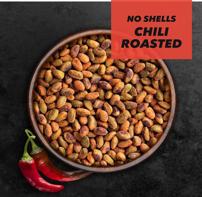 Bowl of Wonderful No Shells Chili Roasted Pistachios with red chili peppers on a dark background.