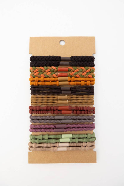Set of colorful woven hair ties on a cardboard display card, assorted neutral and earthy tones