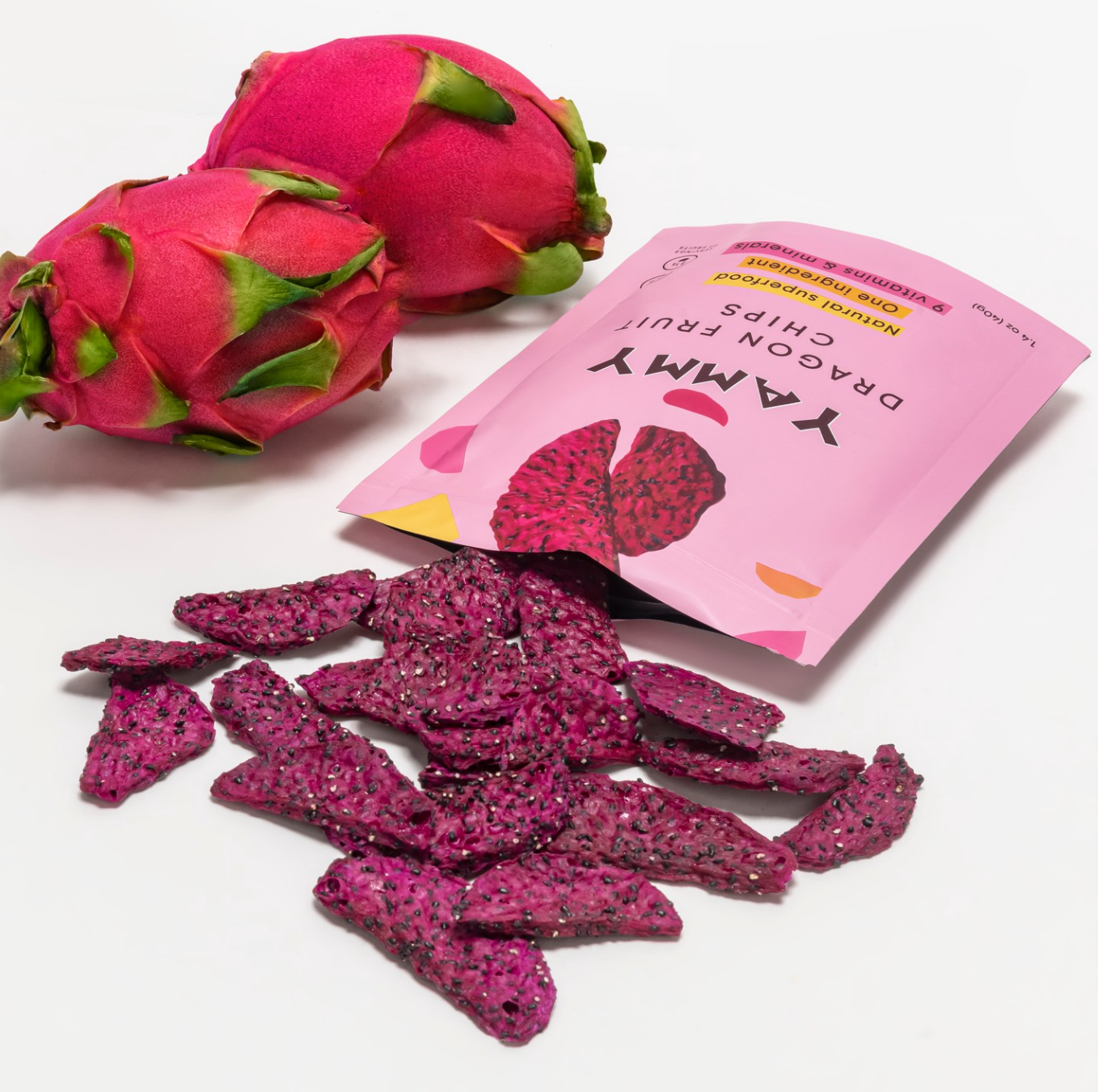Yammy Dragon Fruit Chips in pink packaging with fresh dragon fruit and dried chips on a white background.