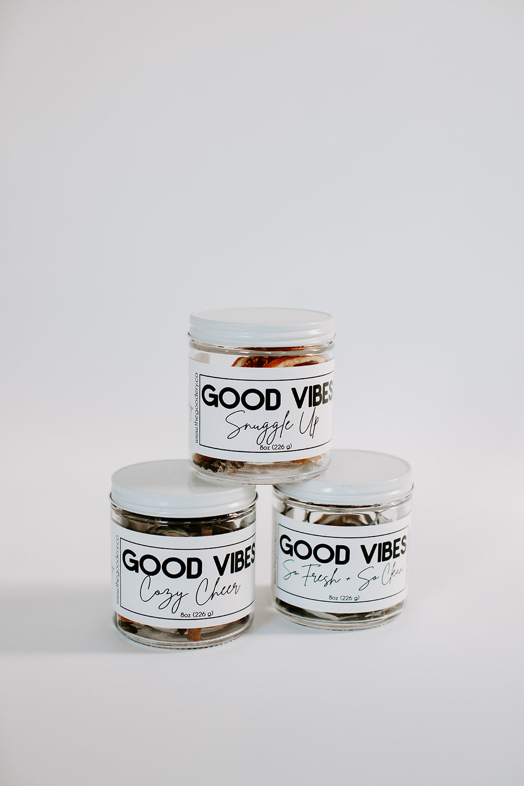 The Goodery Good Vibes Home Refreshers in glass jars, featuring three stovetop simmer blends: So Fresh & So Clean, Cozy Cheer, and Snuggle Up, displayed on a white background.