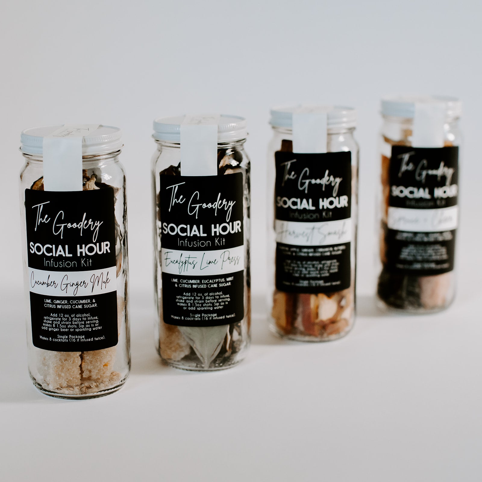 The Goodery Social Hour Infusion Kits in glass jars, featuring Cucumber Ginger Mule and Eucalyptus Lime Press flavors, displayed on a white background for cocktails or zero-proof drinks.